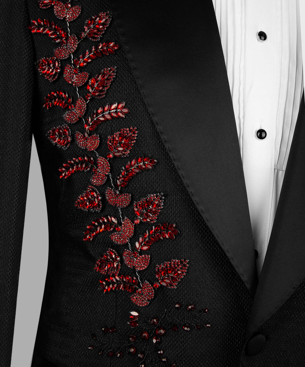 Close-up of black tuxedo lapel embroidery with red crystal floral vines
