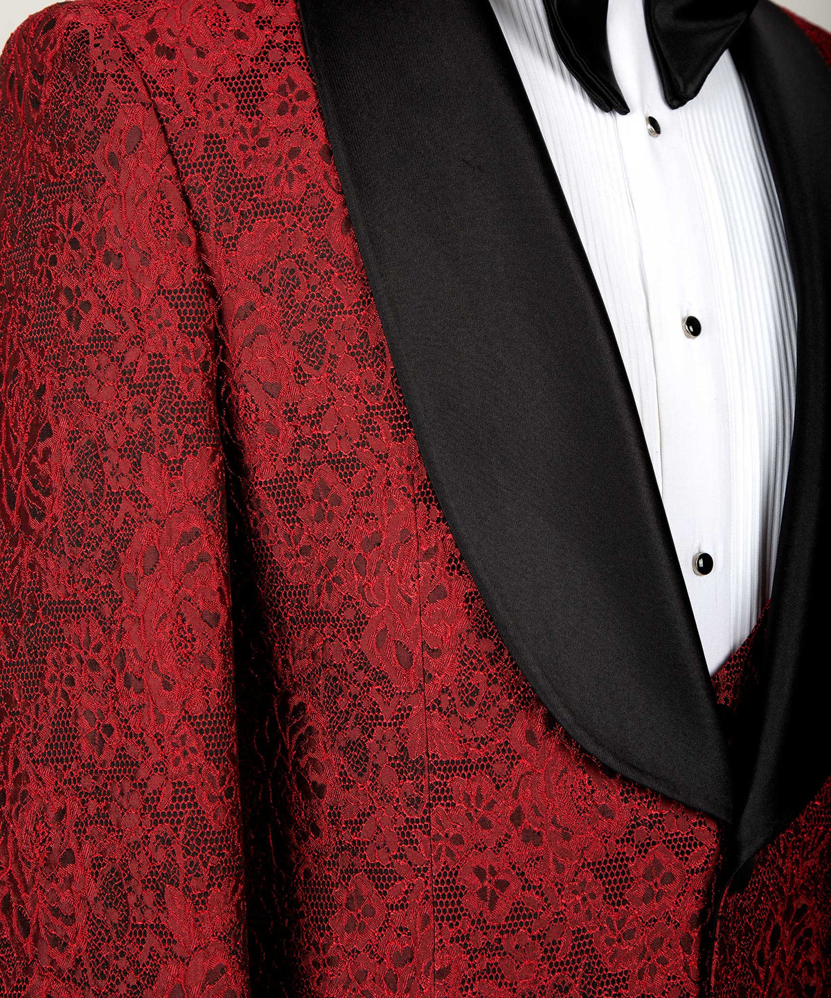 Red jacquard fabric close-up with black satin lapel trim