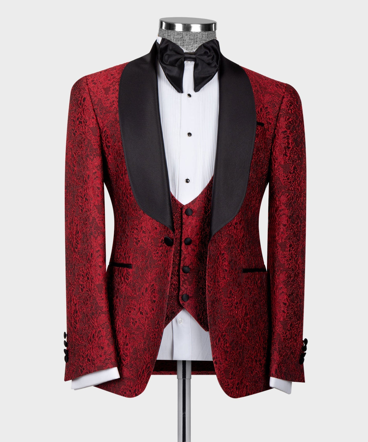 Red patterned tuxedo jacket with satin black shawl collar, bow tie, and matching waistcoat
