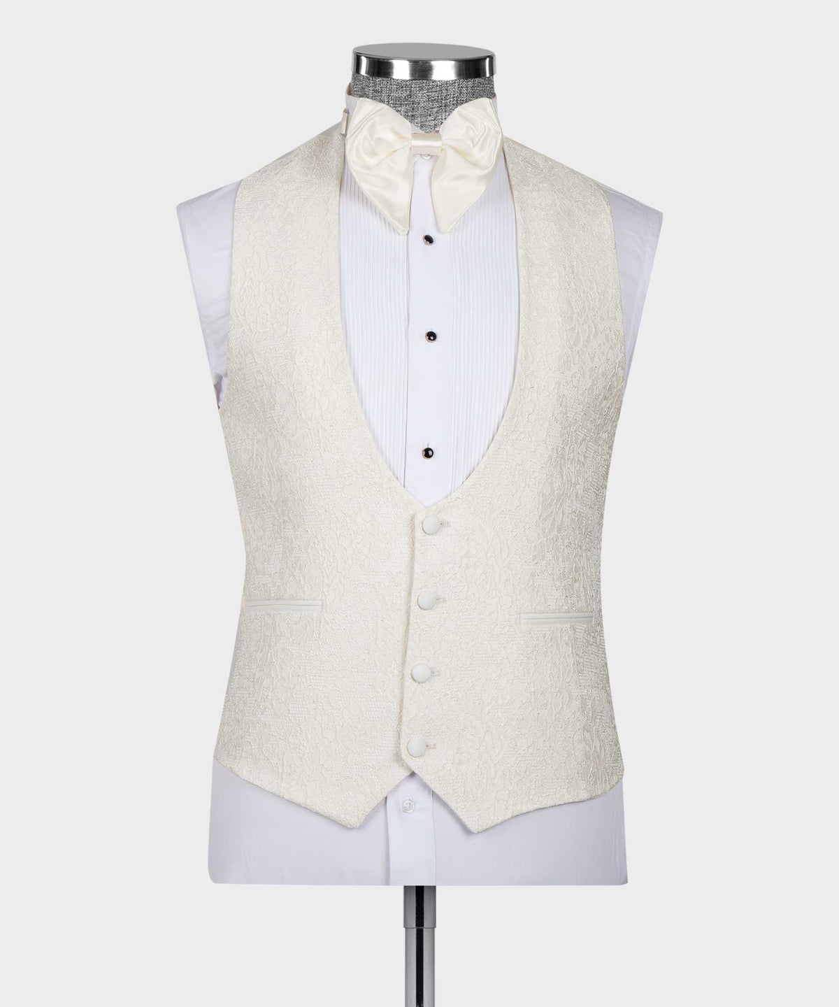 Cream tuxedo vest with four-button front, bow tie and white striped shirt