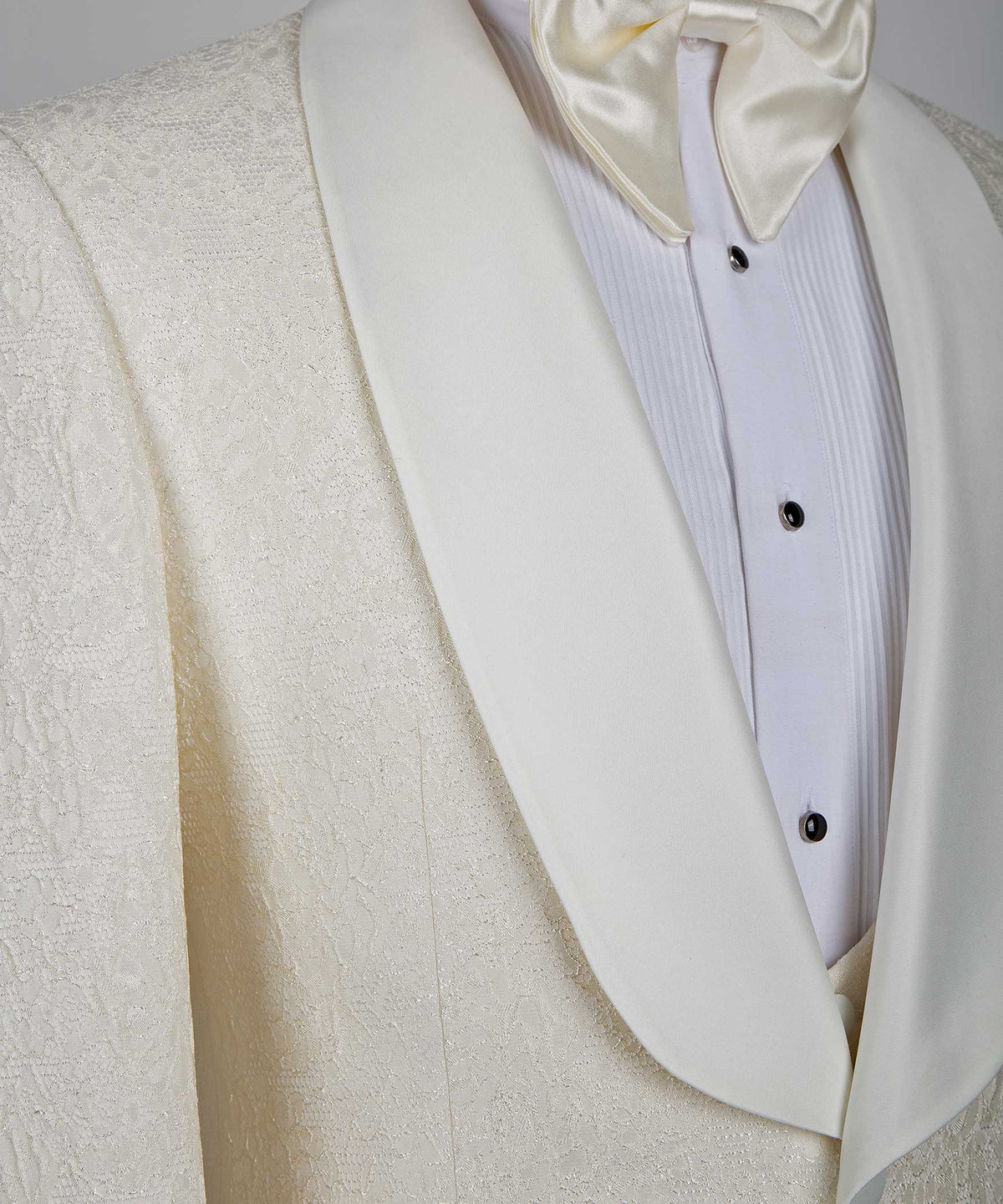 Cream satin lapel and chest placket, black buttons on white dress shirt