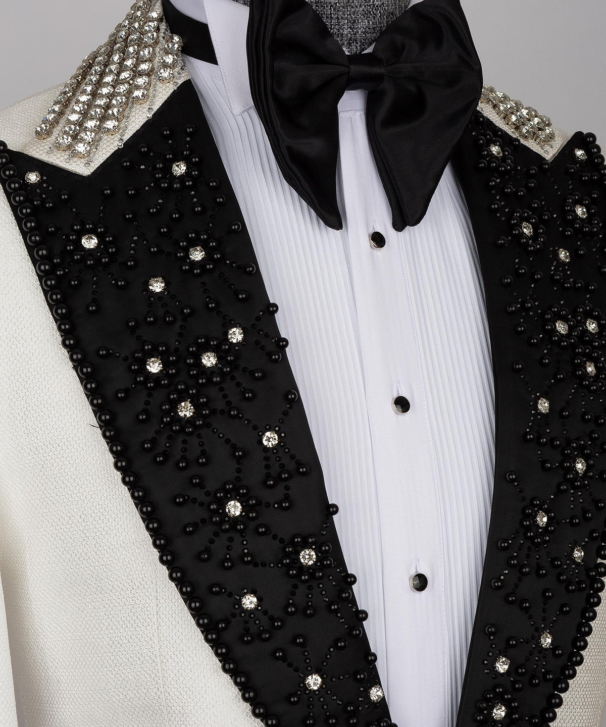 Black jeweled lapels with rhinestone clusters and gold-toned beaded trim