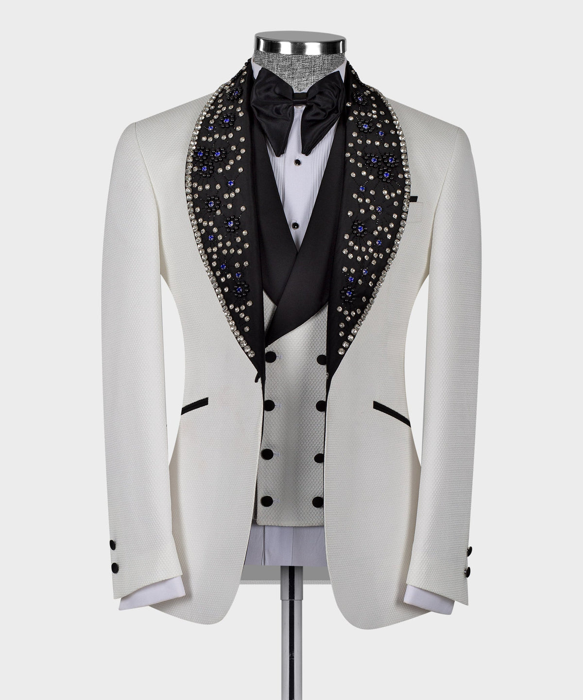 White tuxedo jacket with black satin bow tie and blue crystal gem trim lapels