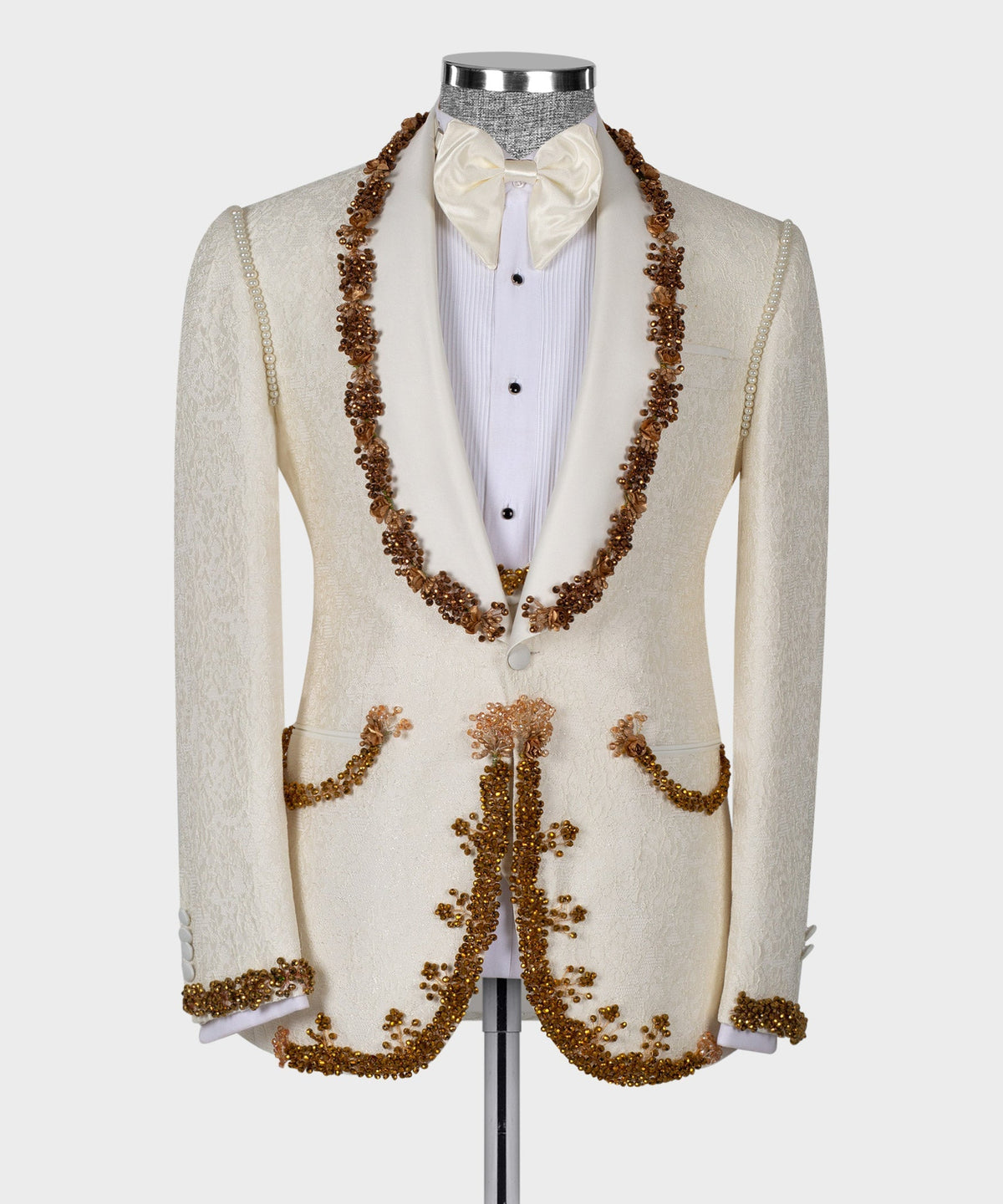 Cream tuxedo jacket with long gold bead garland trim and bow tie over white shirt