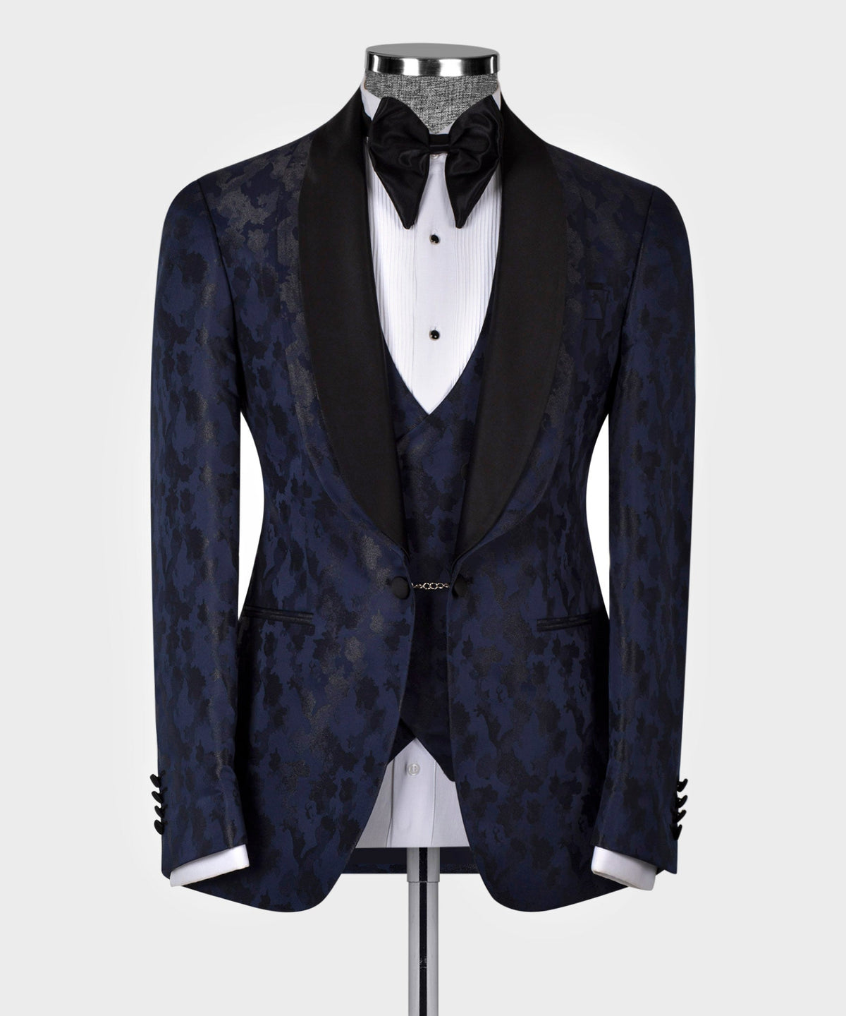 Navy tuxedo jacket with black lapels and bow tie; front vest with pocket chain
