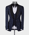 Navy tuxedo jacket with double lapels, black satin trim, bow tie, and patterned vest