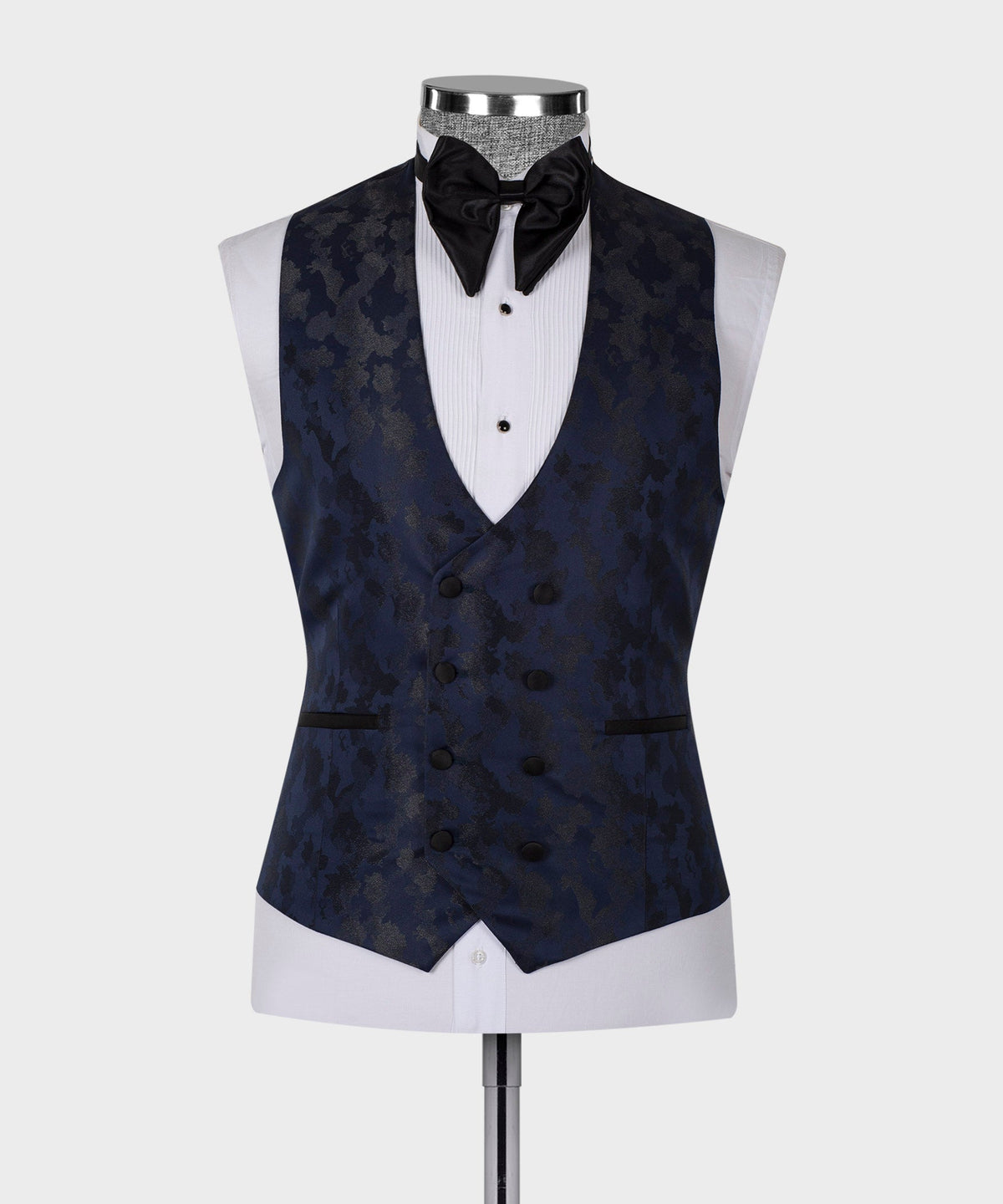 Navy tuxedo vest with black bow tie and white pleated shirt front, double-breasted look
