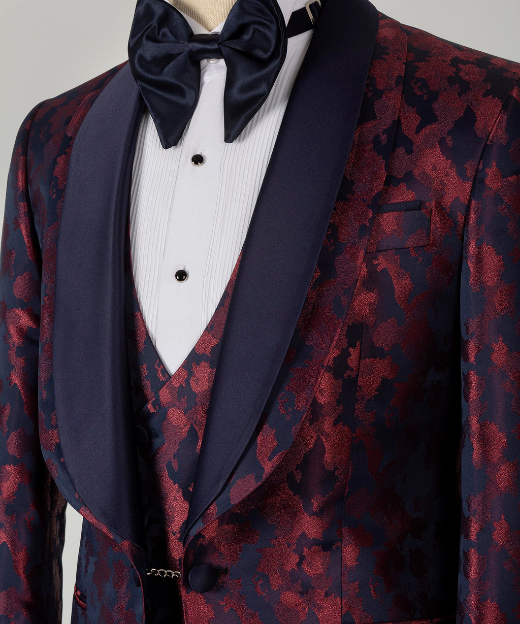 Close-up of tuxedo bow tie and double lapels; burgundy patterned fabric on dark blue