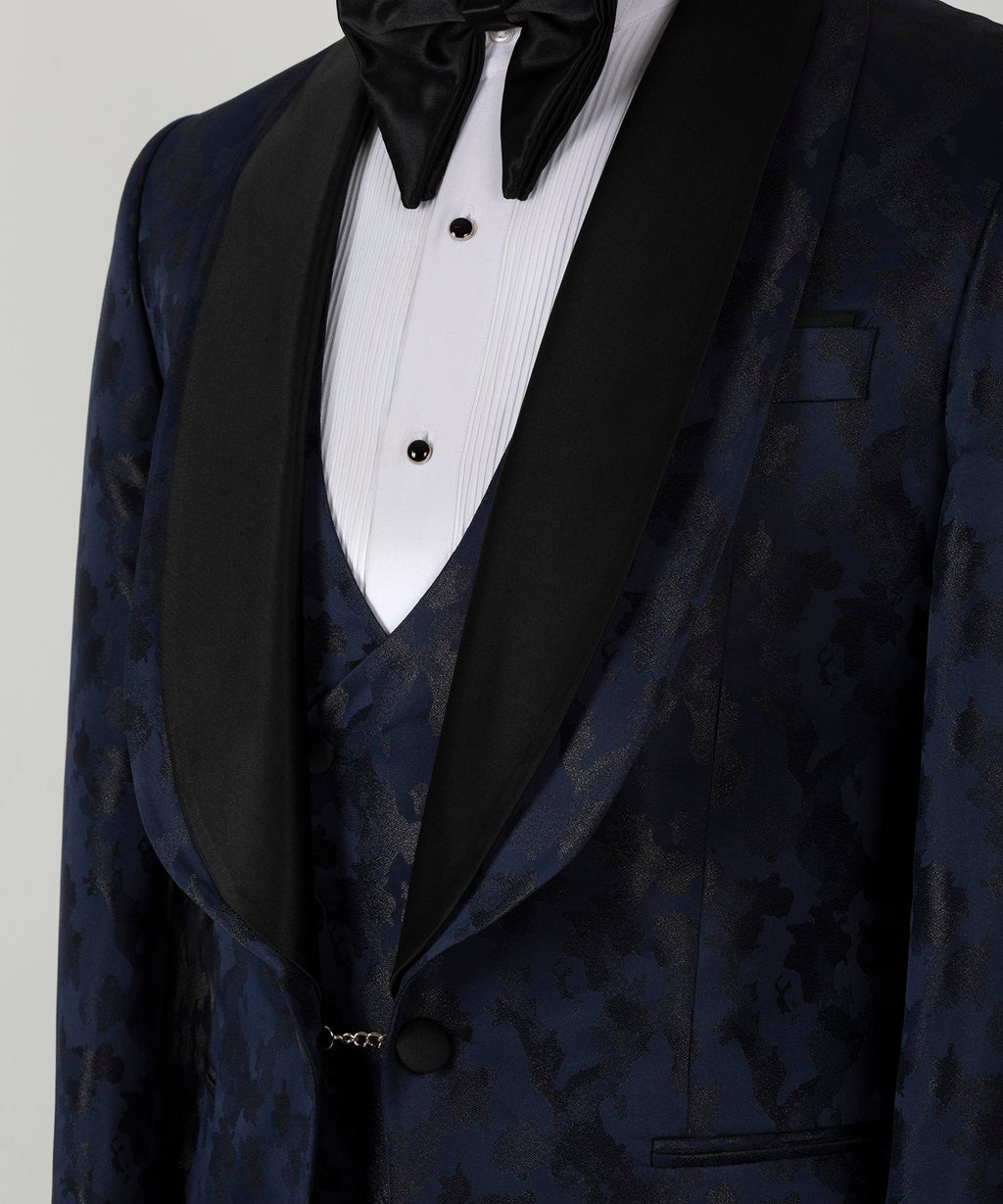 Close-up of black satin lapels, bow tie, vest buttons, and chest pocket detail
