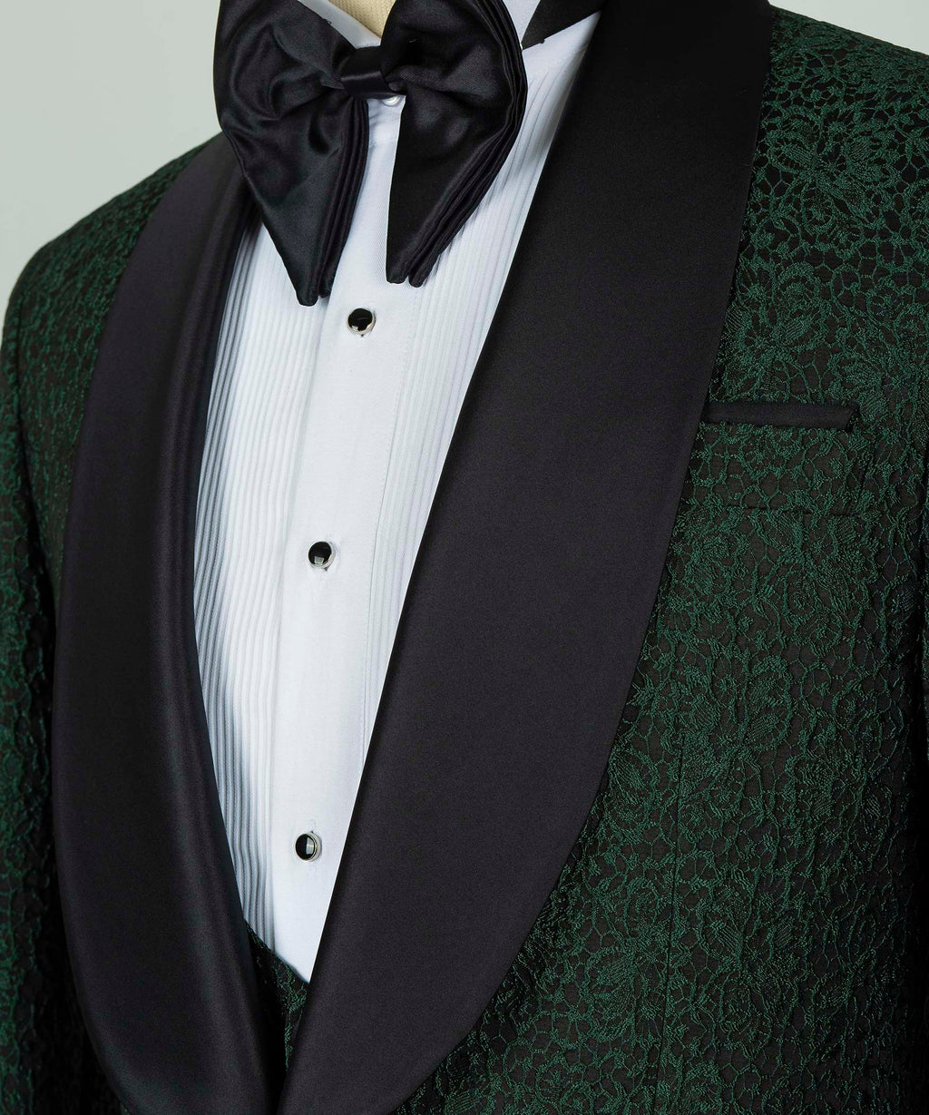 Black satin bow tie with white striped shirt and green patterned waistcoat