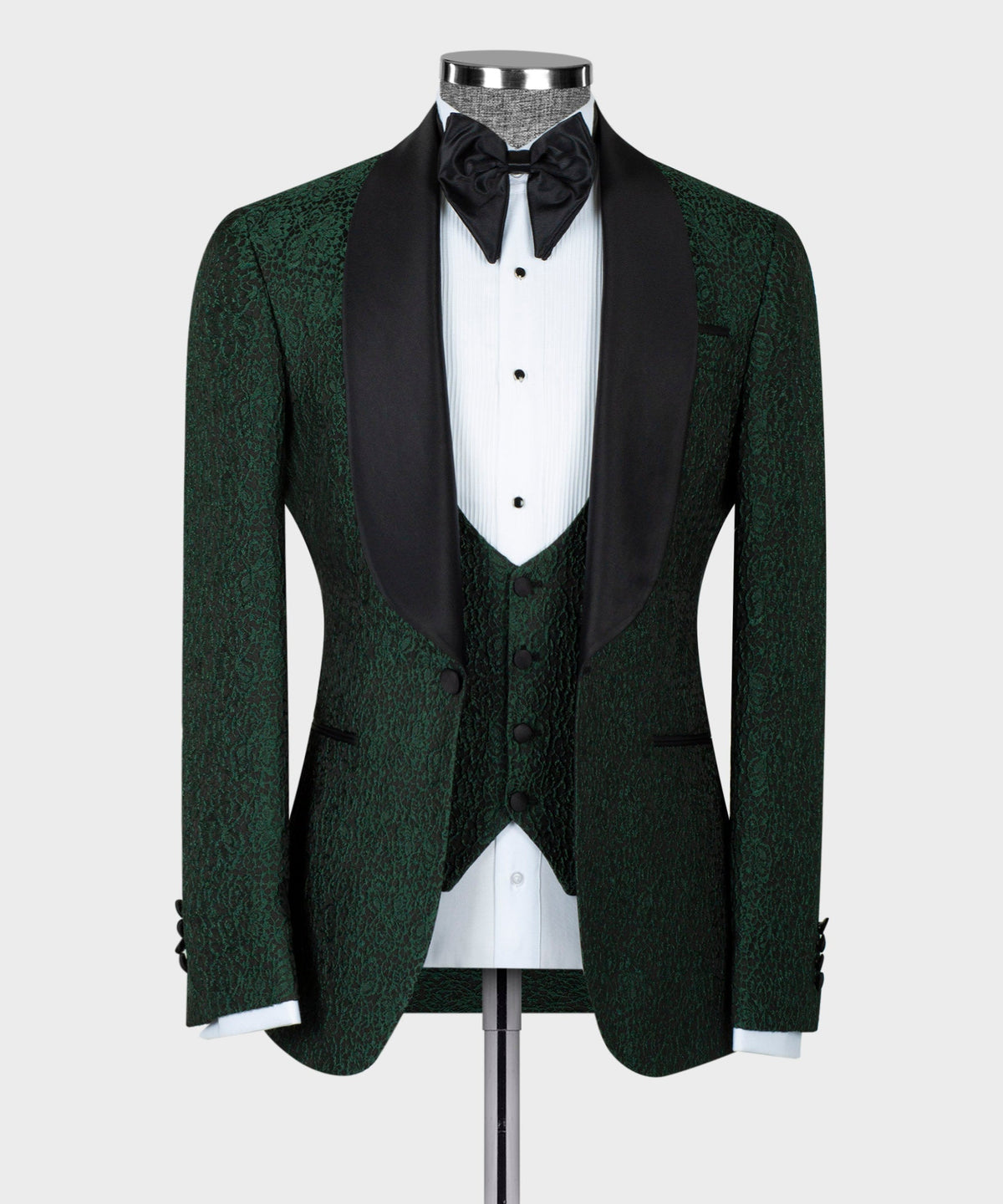 Green tuxedo jacket with black satin lapels, bow tie, and patterned waistcoat