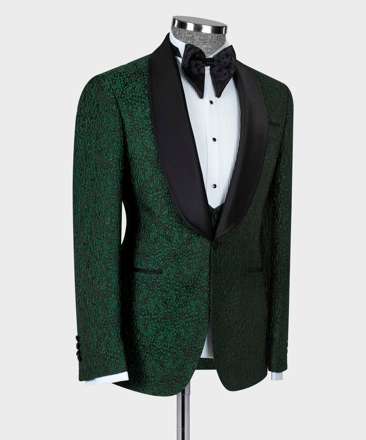 Green tuxedo jacket with black trim and patterned waistcoat at center front