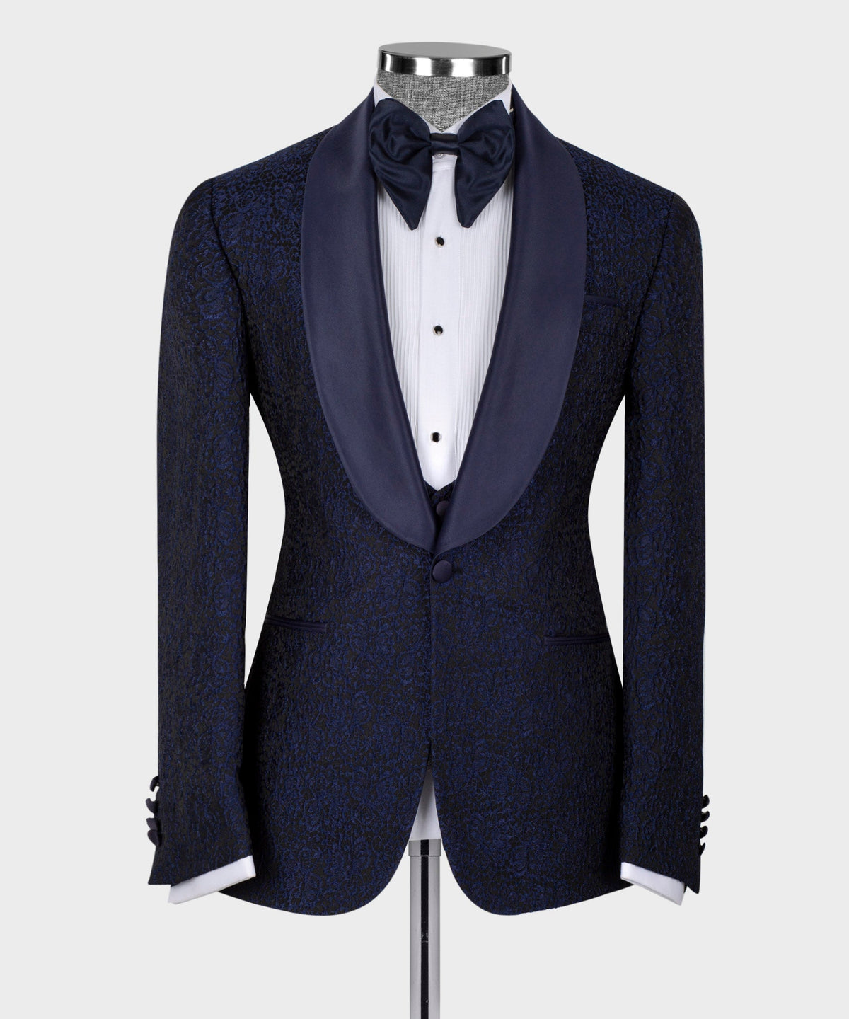 Dark tuxedo jacket with satin lapels and black bow tie; three-piece vest and shirt.