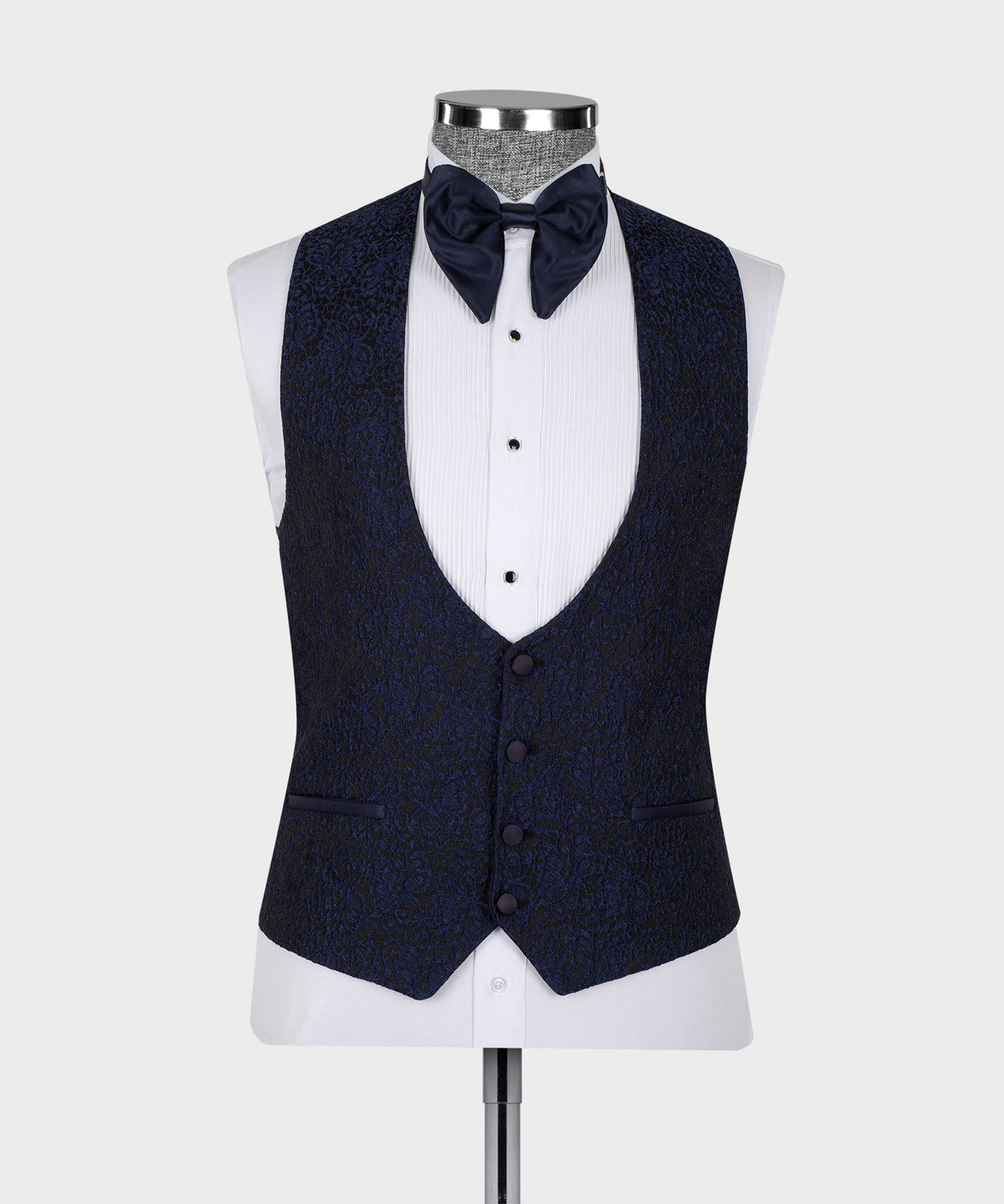 Dark three-piece tuxedo suit vest and jacket with satin collar trim on mannequin.