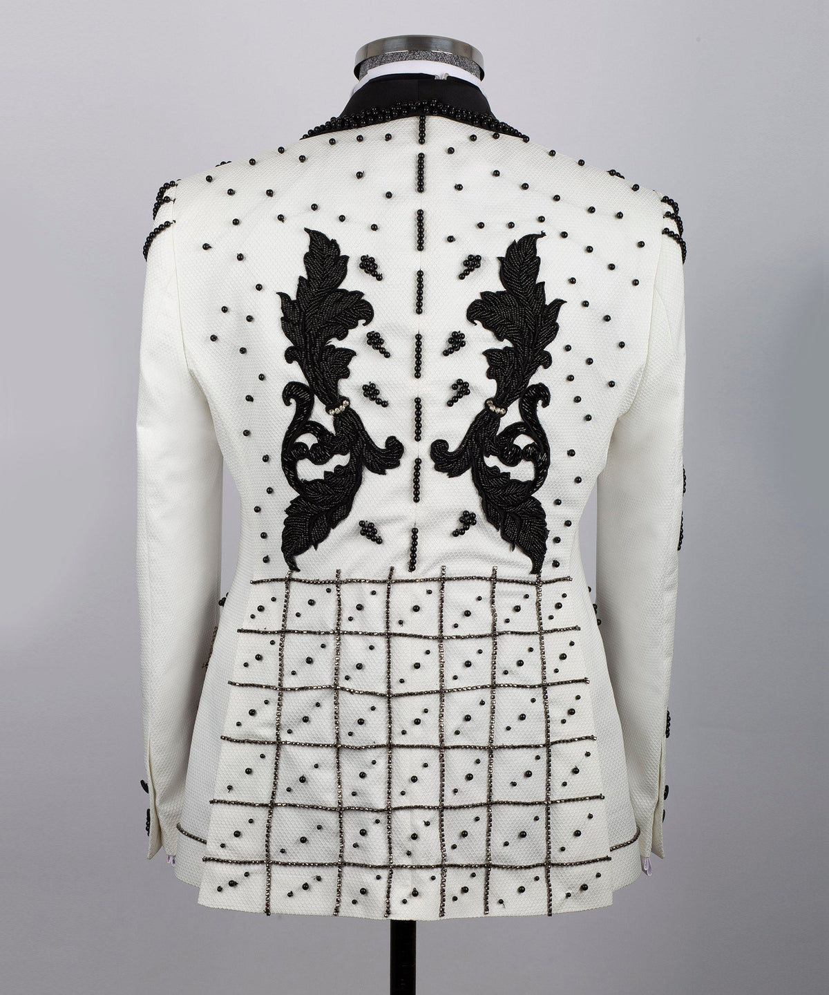 Back view white silk tuxedo jacket with symmetrical black floral crystal details