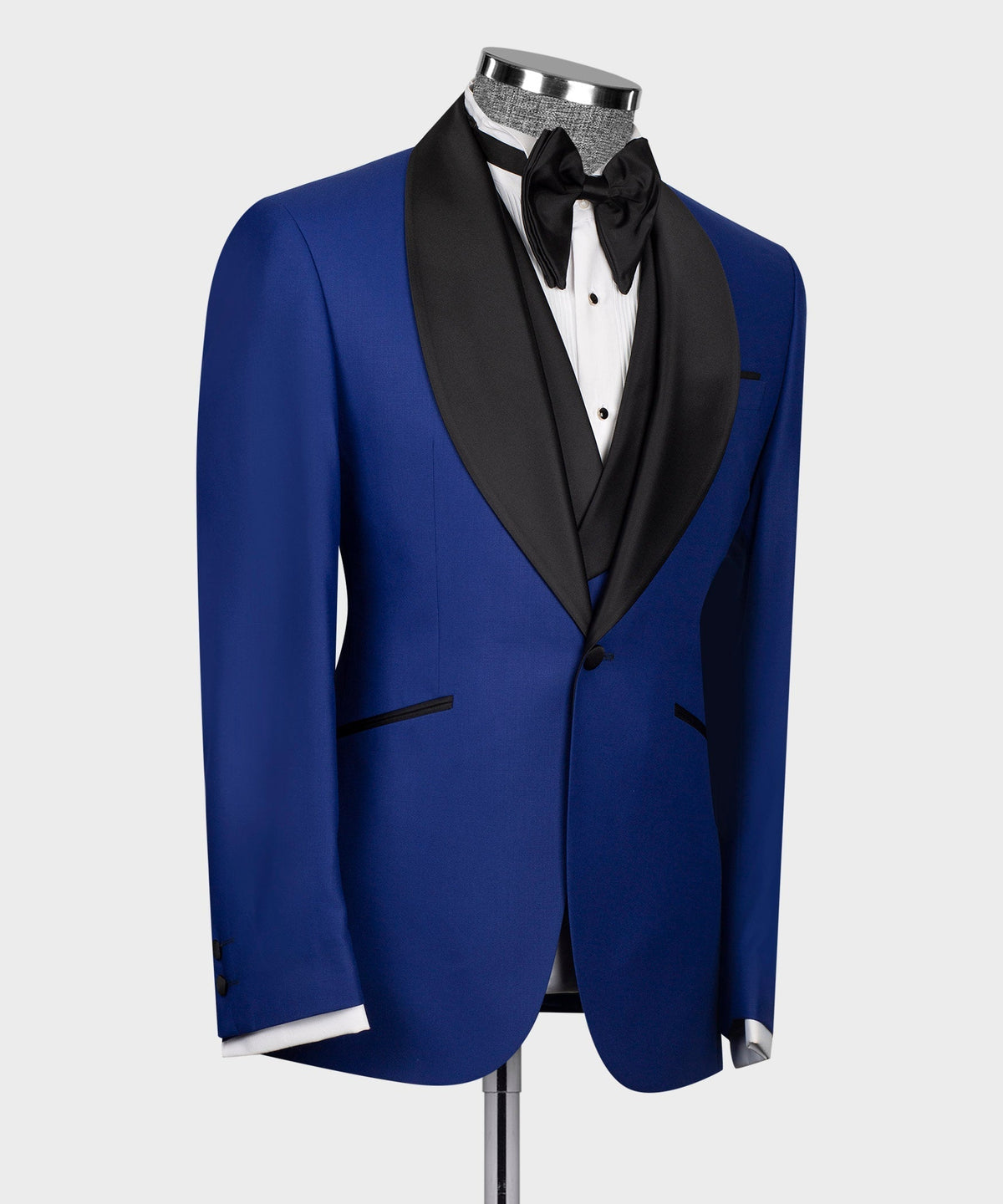 Blue tuxedo jacket with black satin lapel and bow tie, three-quarter view