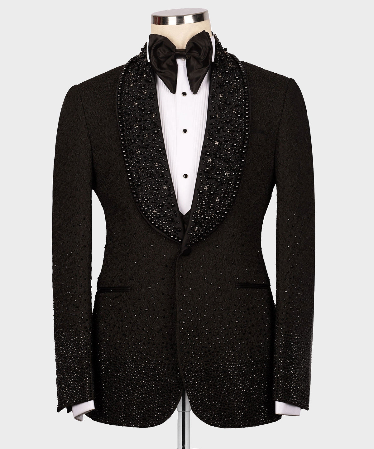 Black tuxedo jacket with rhinestone lapels, bow tie, and white dress shirt