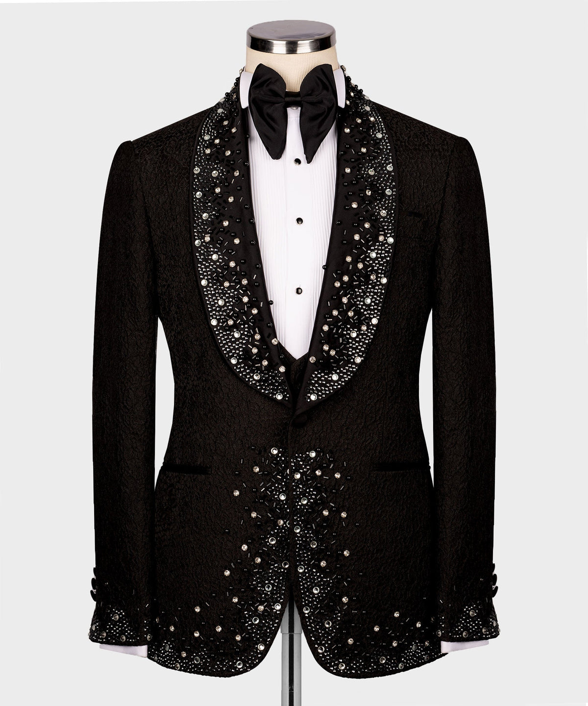Black tuxedo suit: jeweled lapels, embellished waistcoat, black bow tie