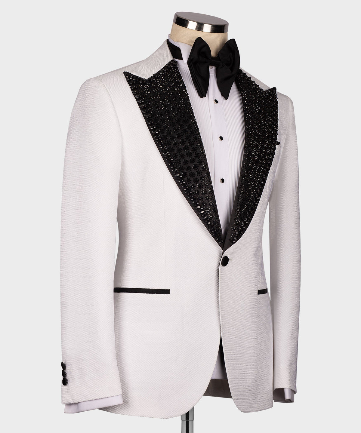 White tuxedo jacket with black glitter lapel trim and black bow tie, side angle