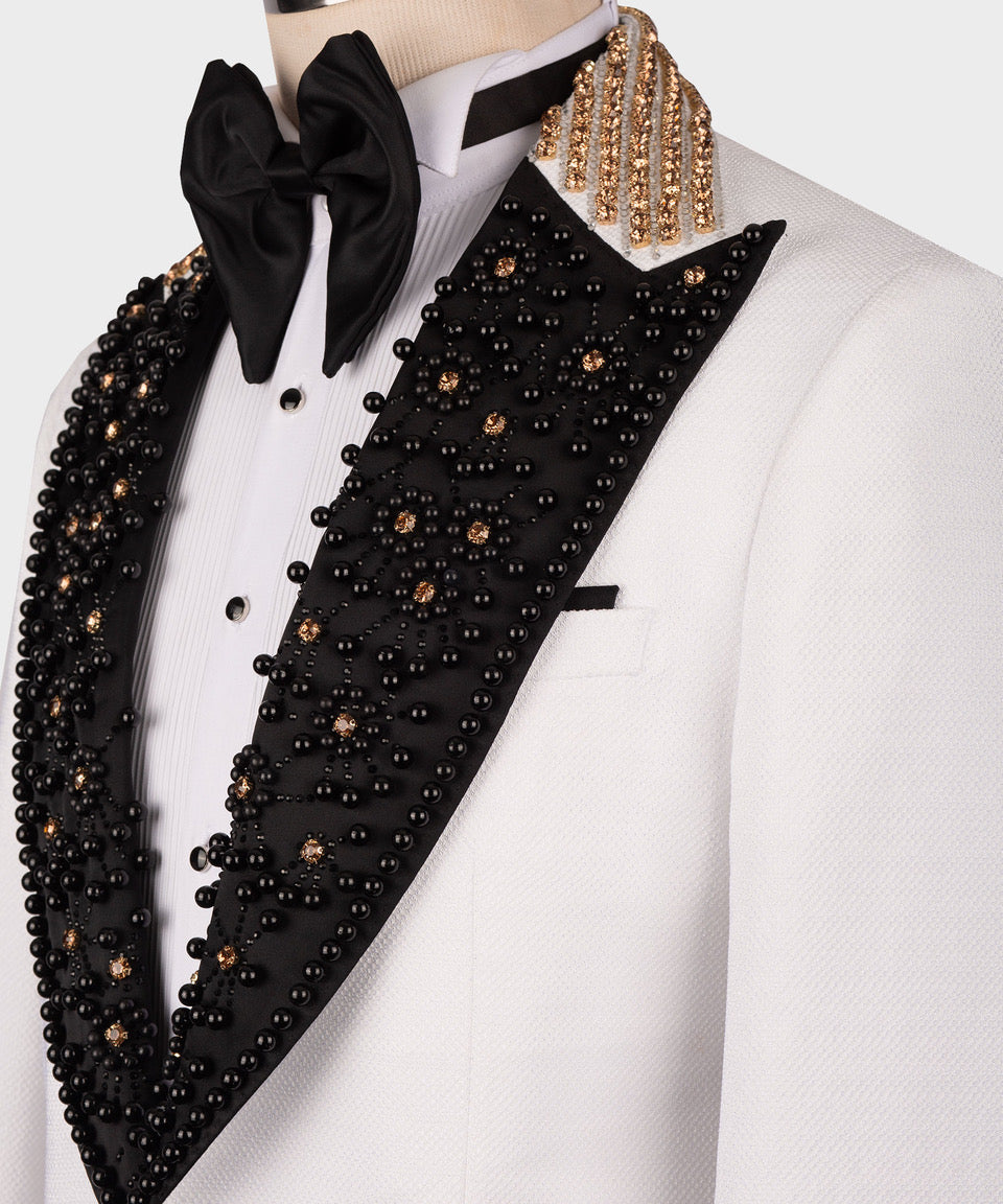 Close-up of black embellished lapel with gold beaded trim and white shirt placket