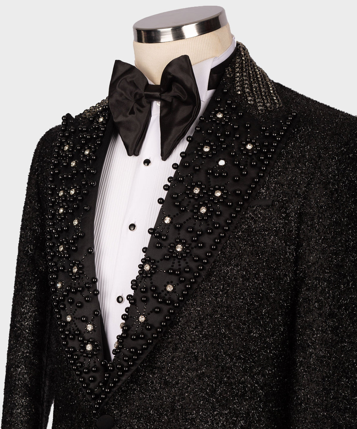 Close-up black tuxedo lapel and waistcoat with dense crystal bead embellishment