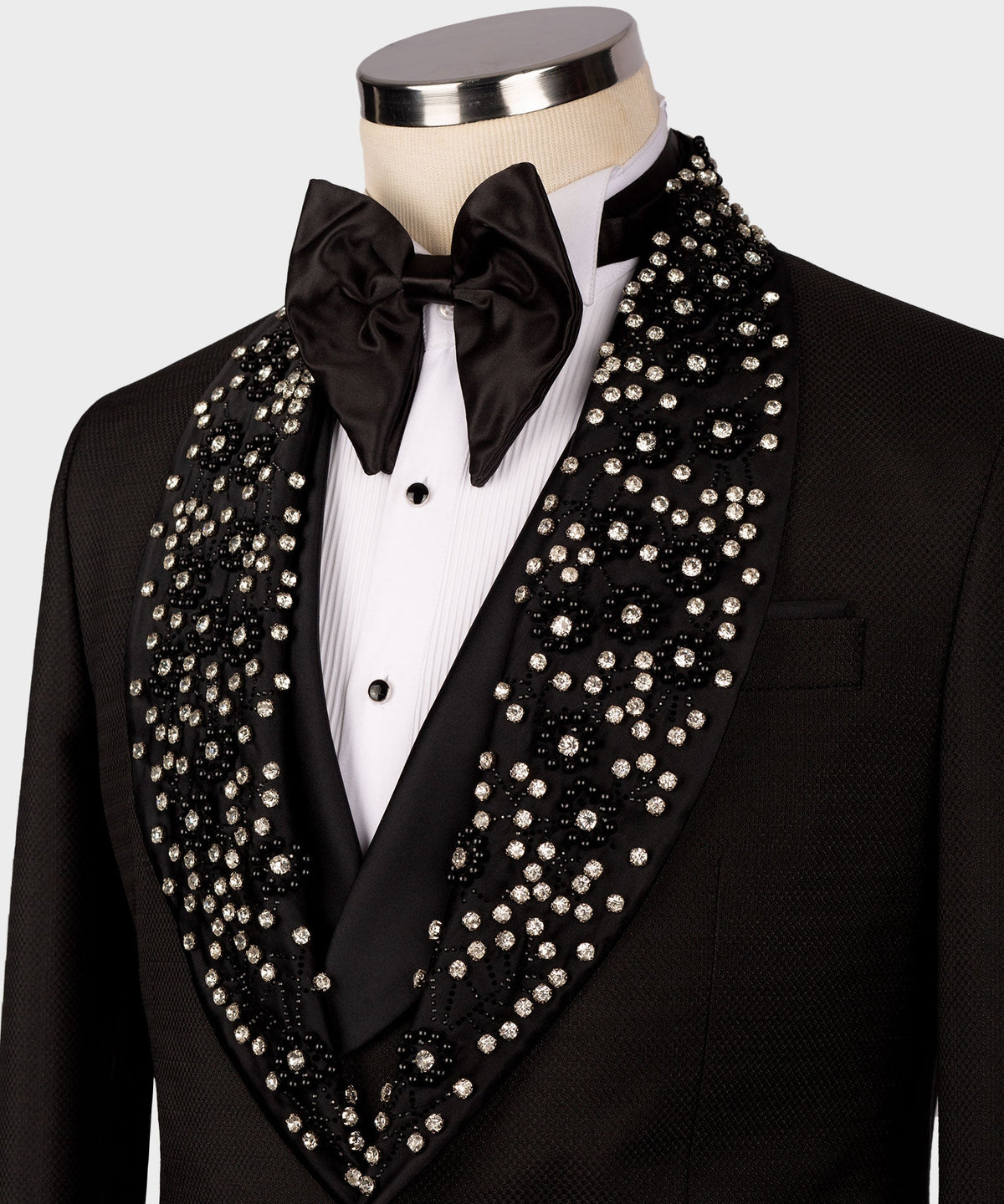 Close-up: black tuxedo with satin bow tie and rhinestone-trim lapels