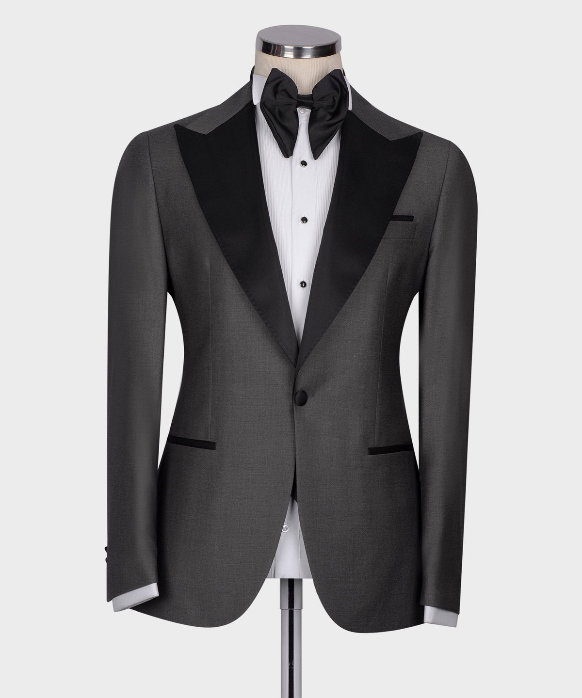 Charcoal gray tuxedo jacket front with black shawl lapels and white striped dress shirt