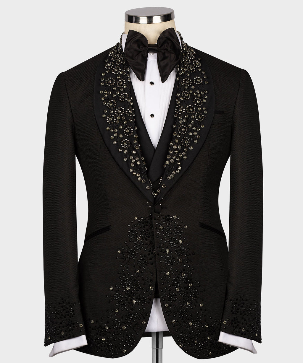 Black custom tuxedo jacket with jeweled lapel detailing, satin bow tie, and white shirt