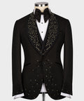 Black custom tuxedo jacket with jeweled lapel detailing, satin bow tie, and white shirt