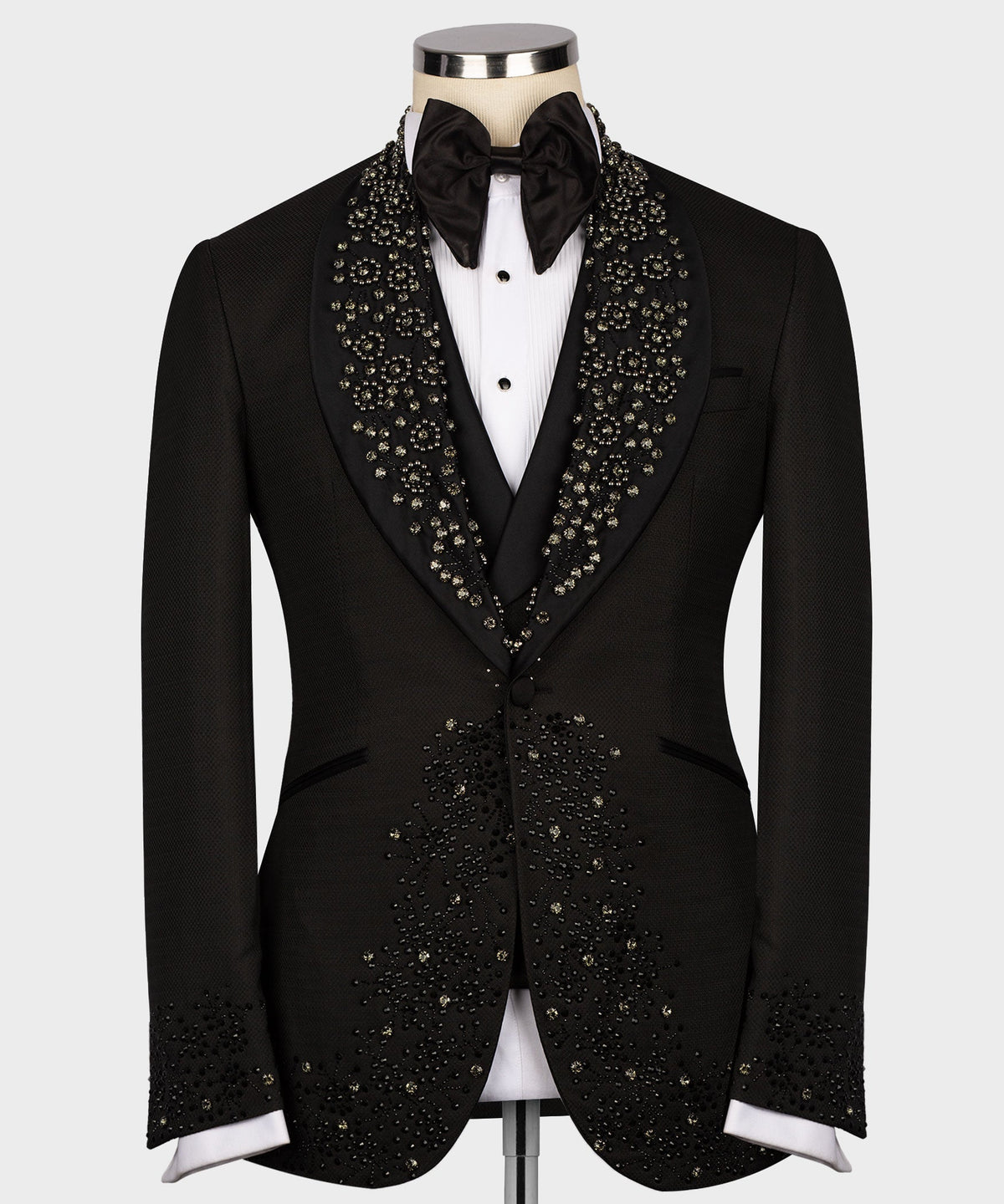 Black custom tuxedo jacket with jeweled lapel detailing, satin bow tie, and white shirt