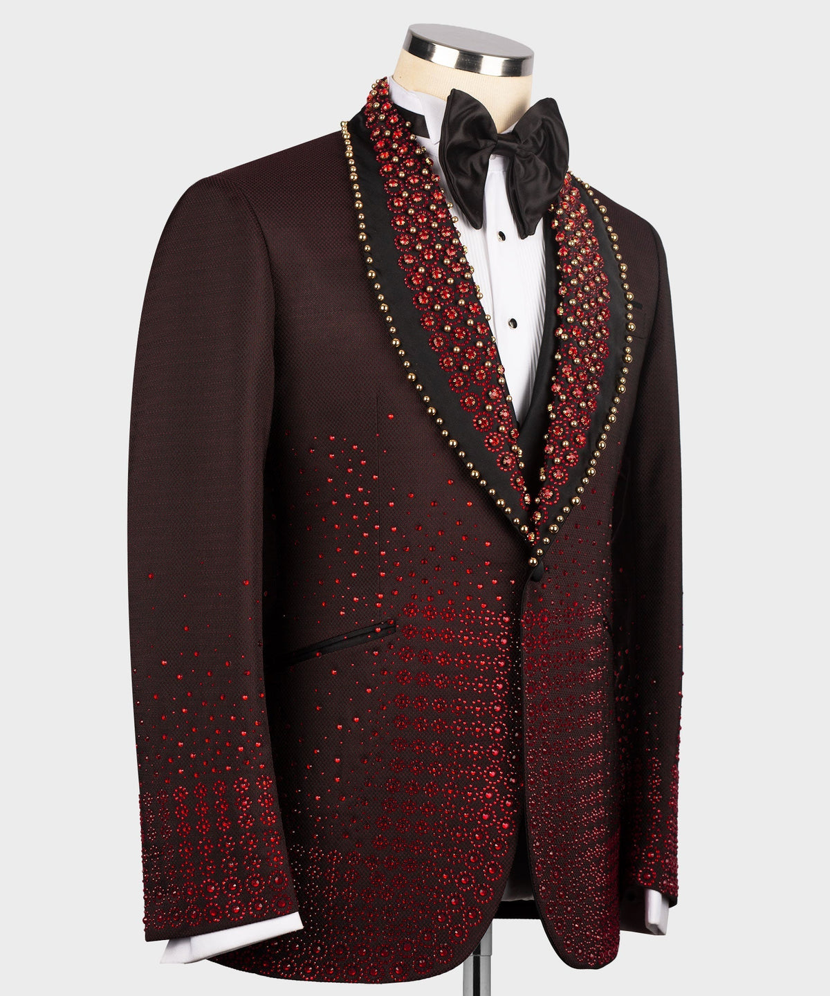 Burgundy tuxedo jacket with red patterned panels, black bow tie, and satin lapel trim