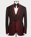 Burgundy tuxedo jacket with red and gold patterned lapels, black bow tie and vest