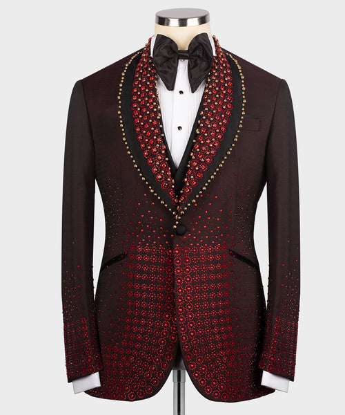 Burgundy tuxedo jacket with red and gold patterned lapels, black bow tie and vest