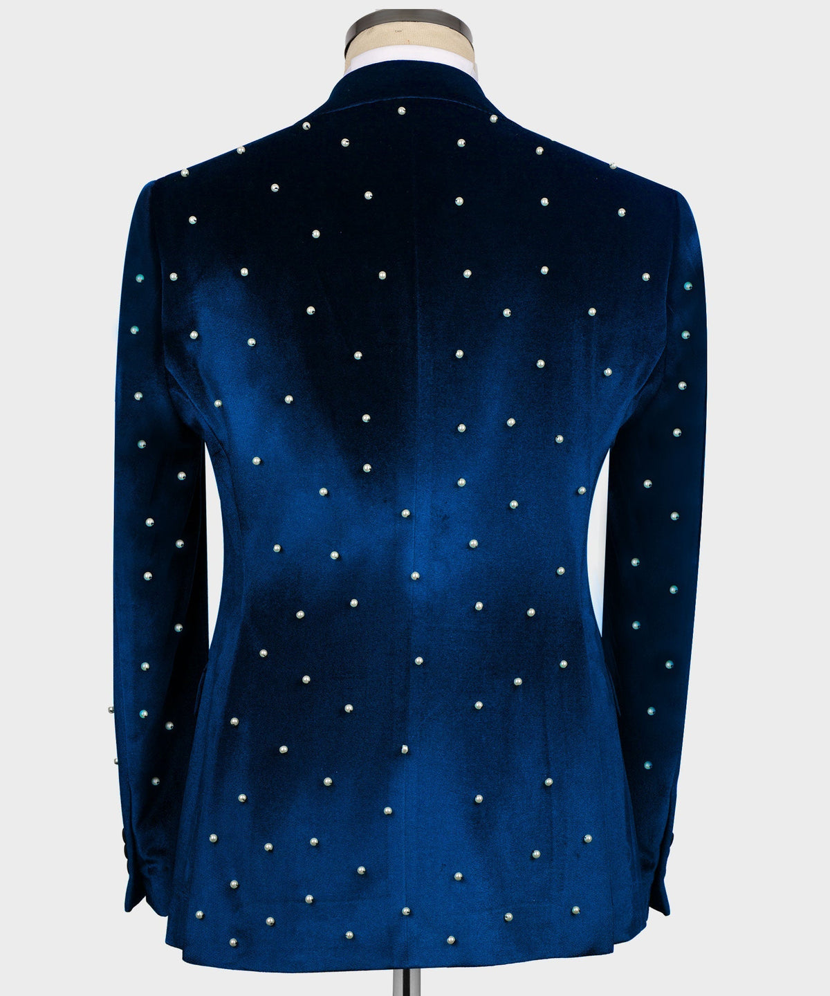 Back view of blue velvet tuxedo jacket with pearl bead details across the fabric
