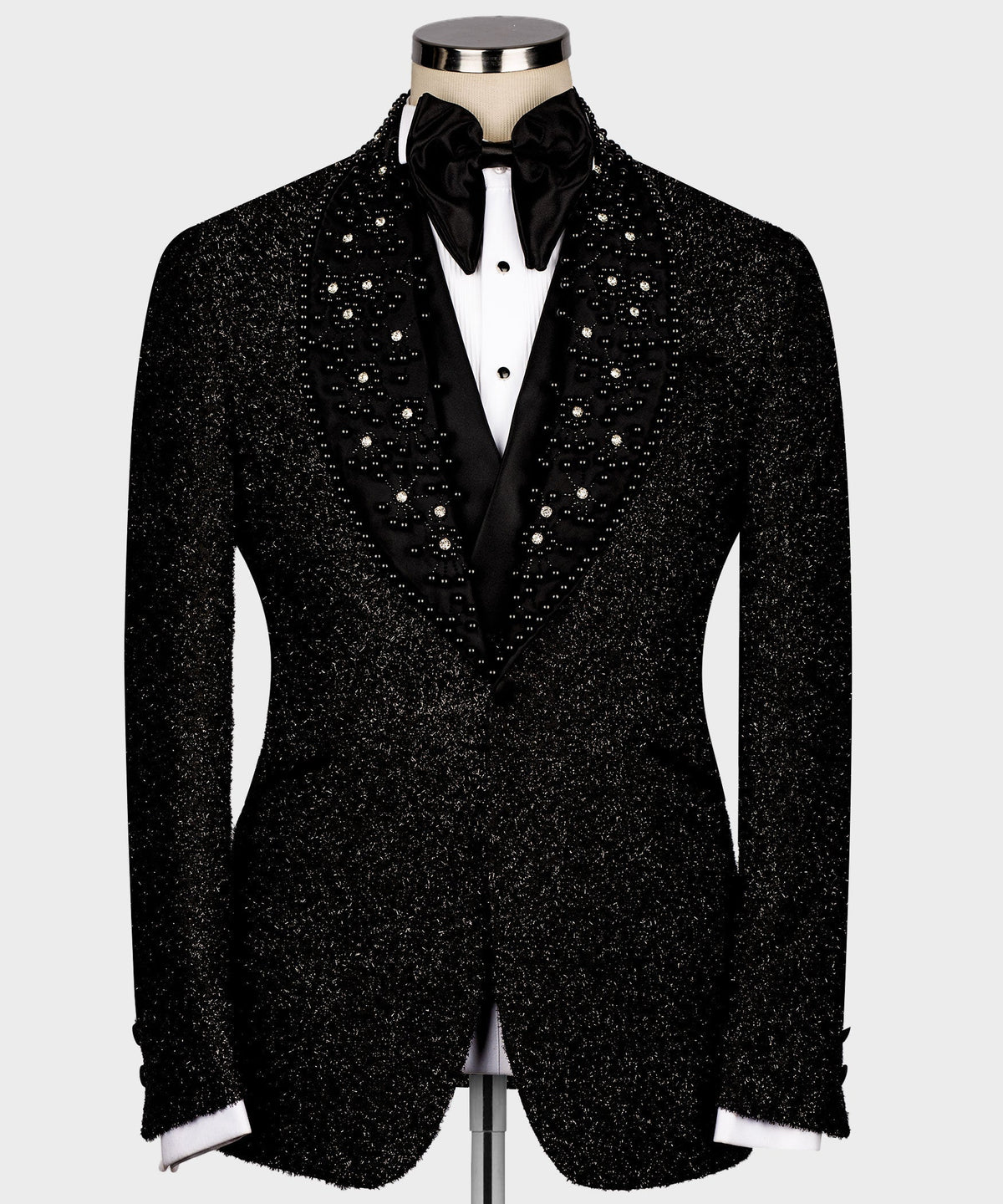 Black glitter tuxedo jacket with satin lapels and button front, white shirt cuffs