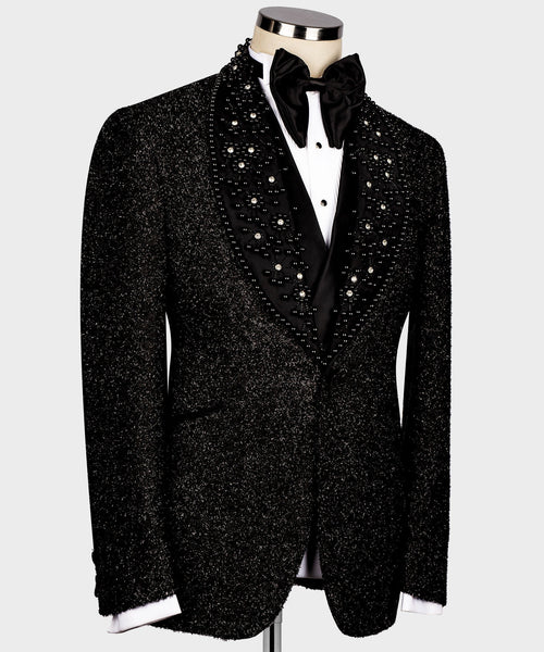 Black sparkly tuxedo jacket with rhinestone buttons and white shirt cuffs, front view