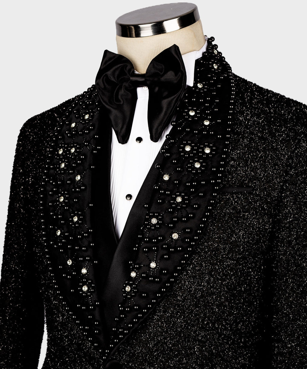 Black glitter tuxedo jacket close-up with jeweled lapels, black bow tie and white shirt