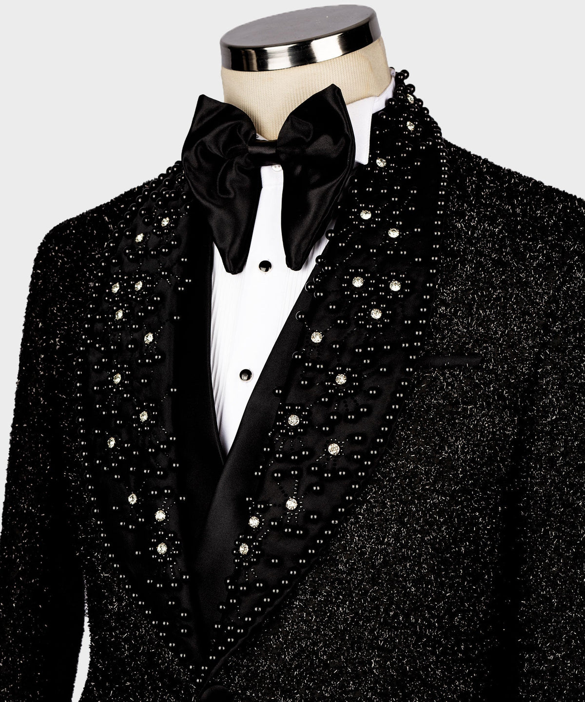 Black tuxedo jacket lapels and jeweled front, satin black bow tie and white vest