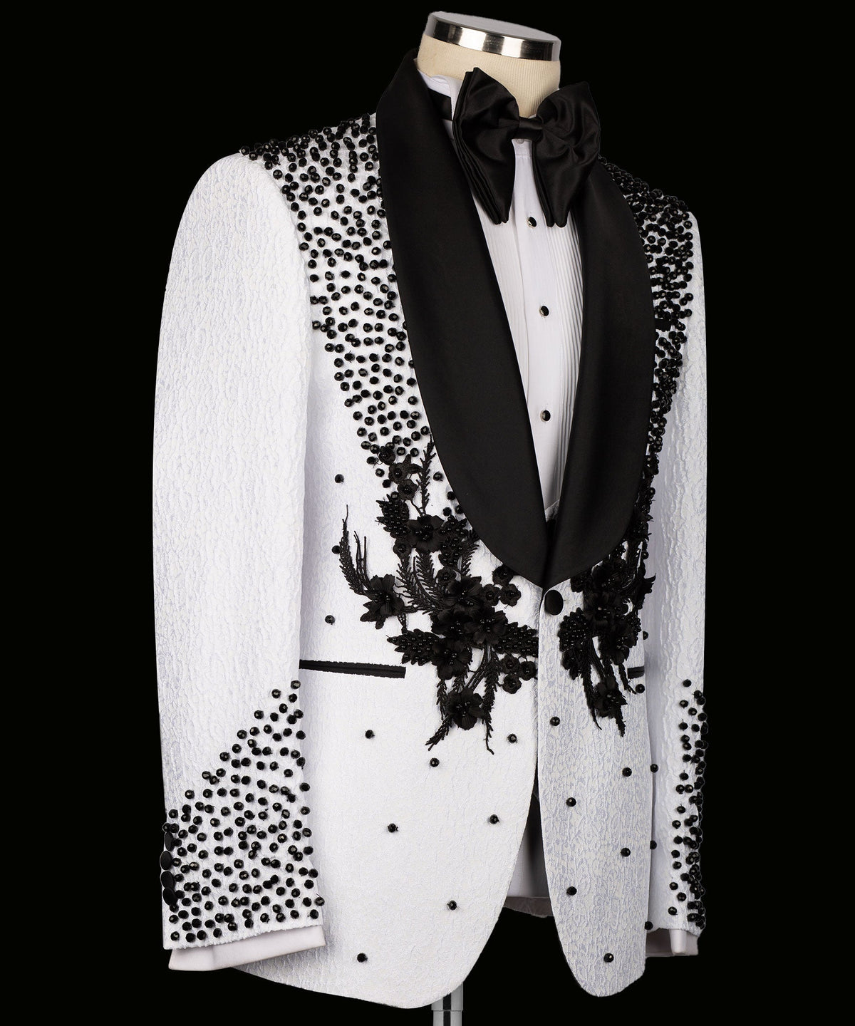 White tuxedo suit jacket with black shawl lapels and floral appliqué on the front
