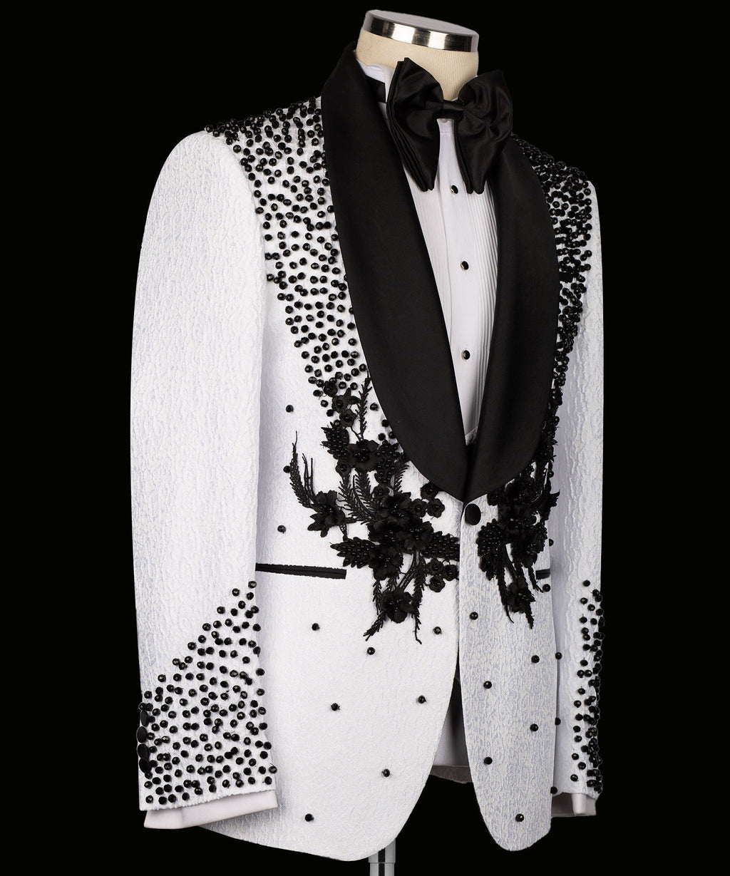 White tuxedo jacket front view with black floral embroidery on lapels and dotted accents