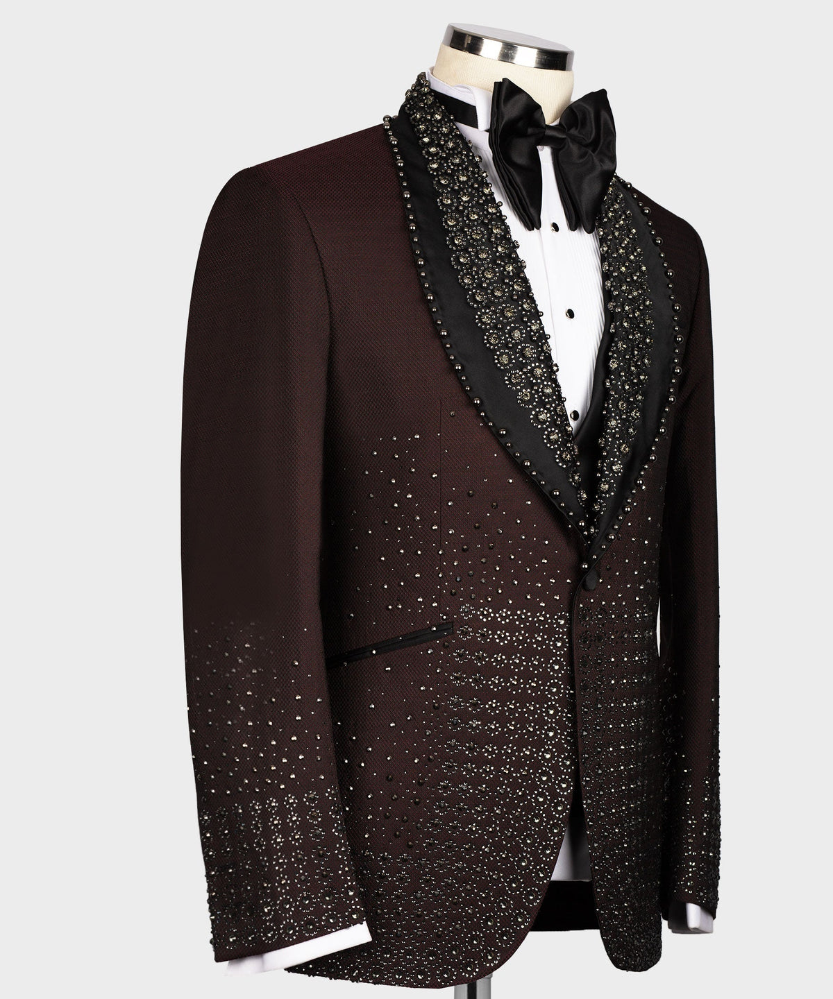 Burgundy tuxedo jacket side view with beaded black lapel trim and matching patterned fabric
