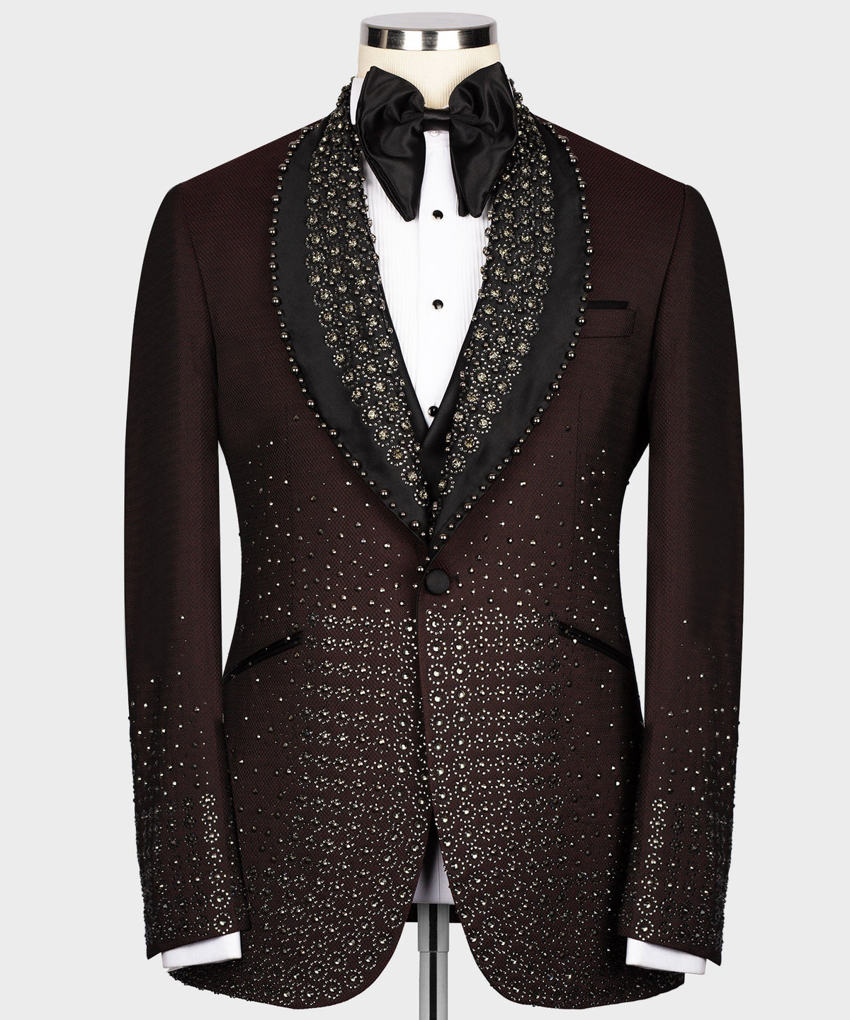 Burgundy tuxedo jacket with round lapels, black satin trim, and gold jeweled pattern