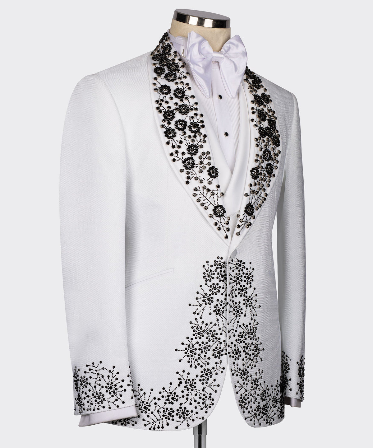 White tuxedo jacket side view, black beaded gemstone embroidery along lapels and front