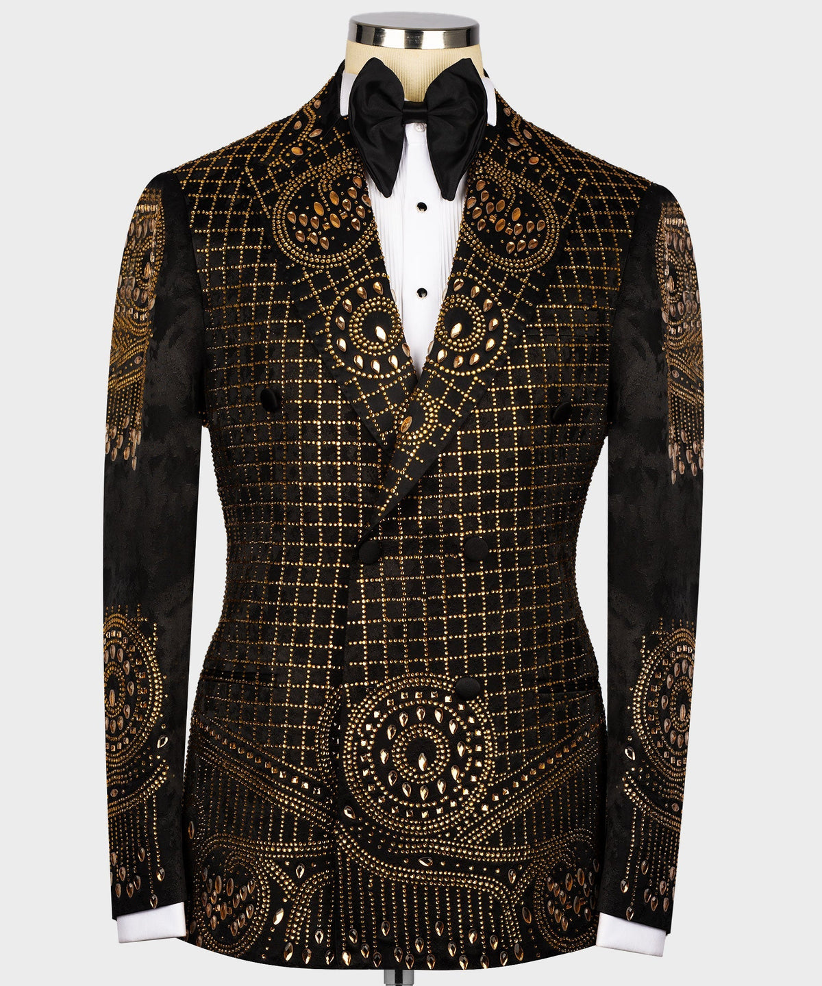 Black tuxedo jacket with gold embroidery, bow tie, and white dress shirt