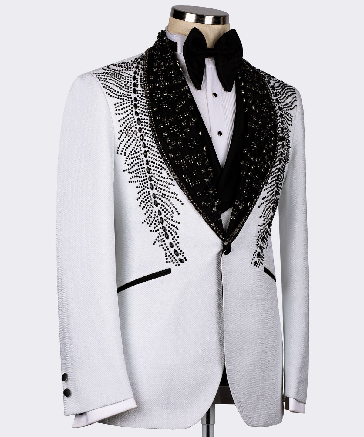 White tuxedo jacket with black lapels and feather-like stone embroidery along the sides
