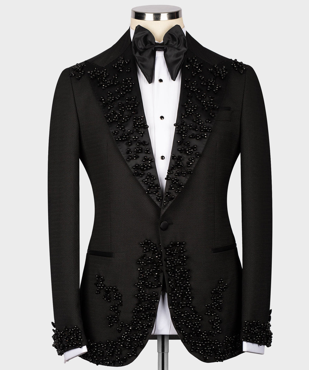 Black tuxedo jacket with jeweled lapels, satin bow tie, and matching vest