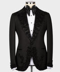 Black tuxedo jacket with jeweled lapels, satin bow tie, and matching vest