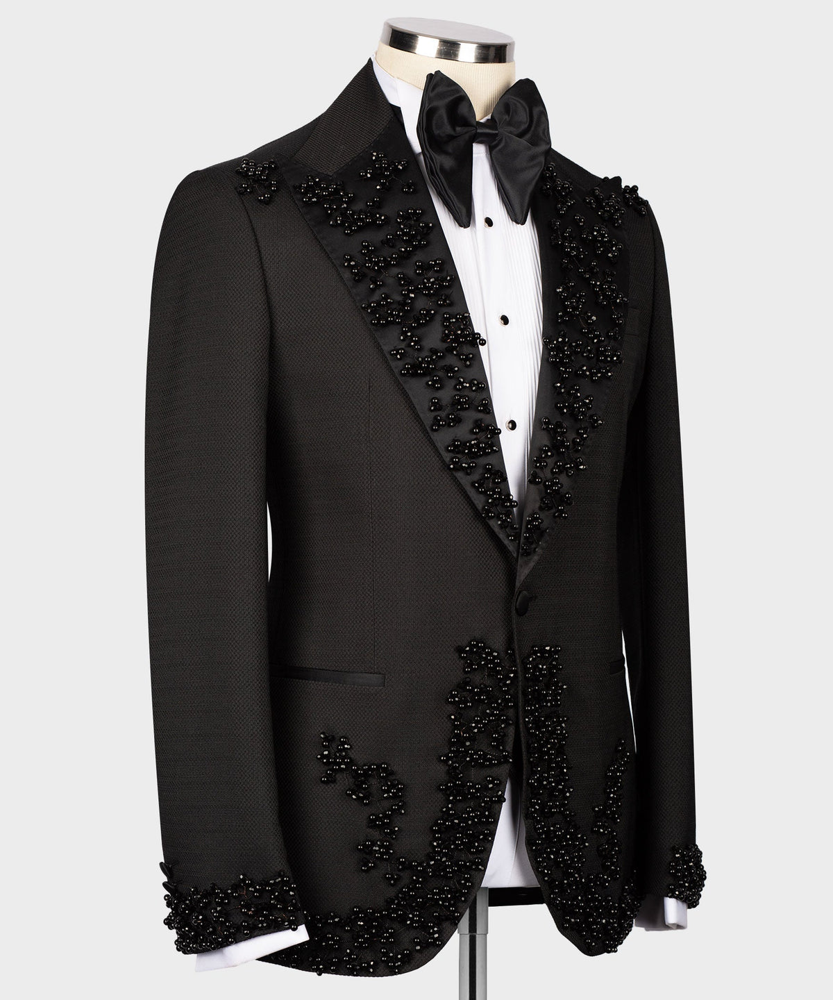 Black tuxedo set with embellished lapels and satin bow tie, front view on mannequin