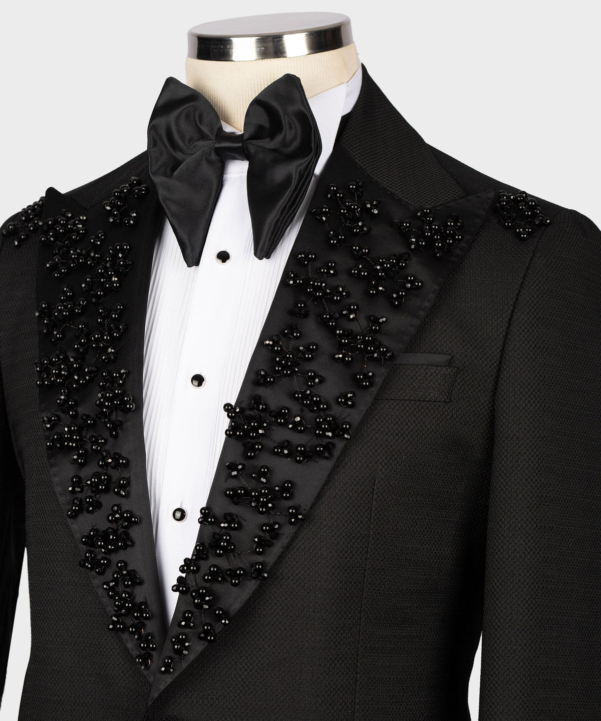 Black tuxedo shirt and satin bow tie with jeweled V-lapel on jacket