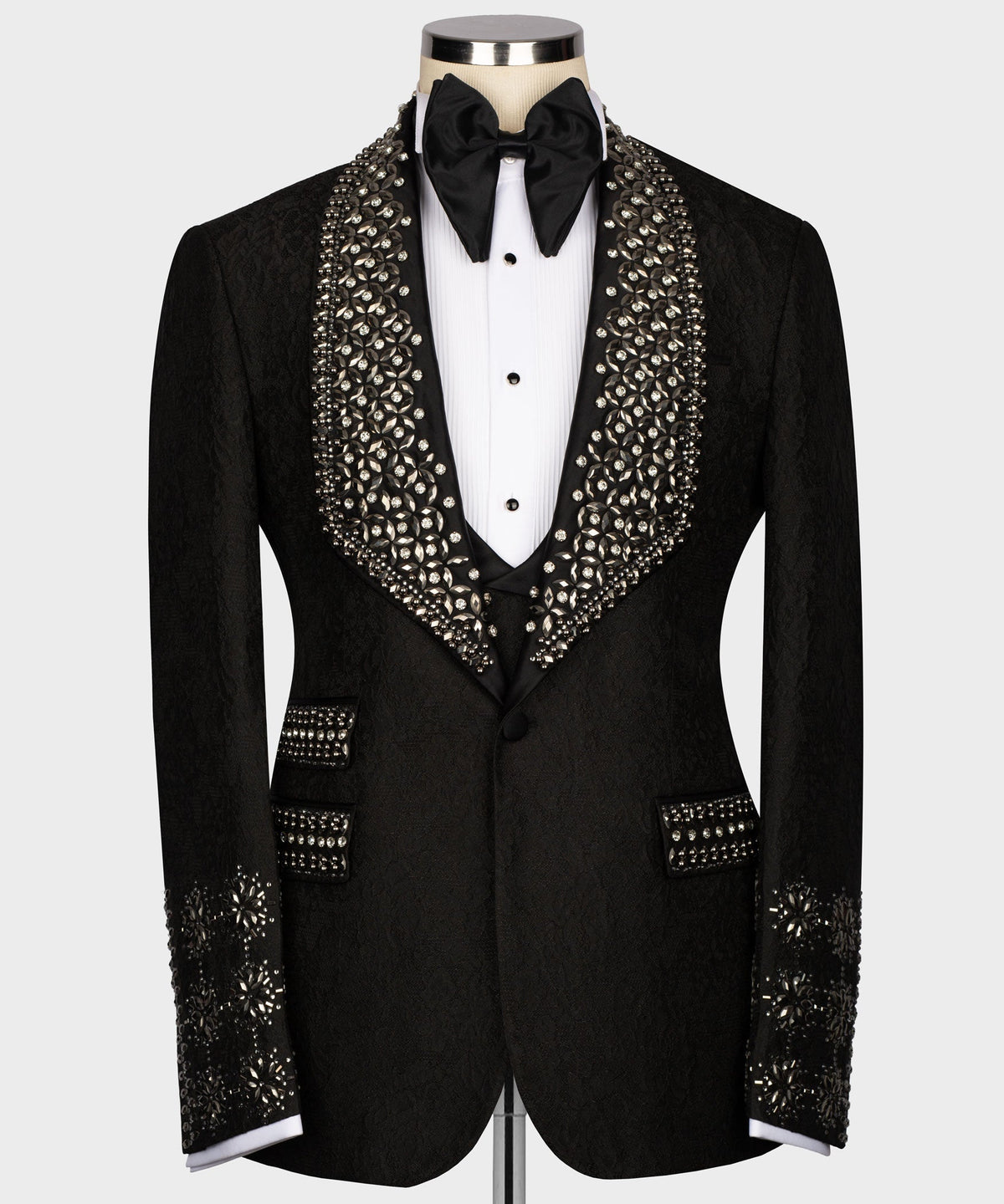 Black tuxedo jacket with crystal-encrusted lapels and satin bow tie, on white shirt